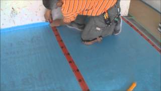 Installing the Underlayment for Laminate Flooring Installation on Wood Mryoucandoityourself [upl. by Werdnaed636]